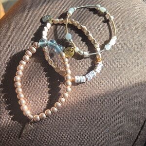 3 Erimish bracelets. One is marked with the date Erimish was created